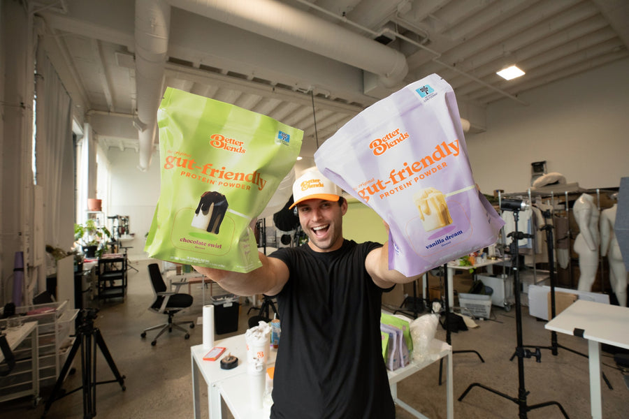 Better Blends founder John Redmond holding bags of Chocolate Swirl and Vanilla Dream
